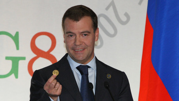 Dimitri Medcedev at G8 sum showing a gold coin
